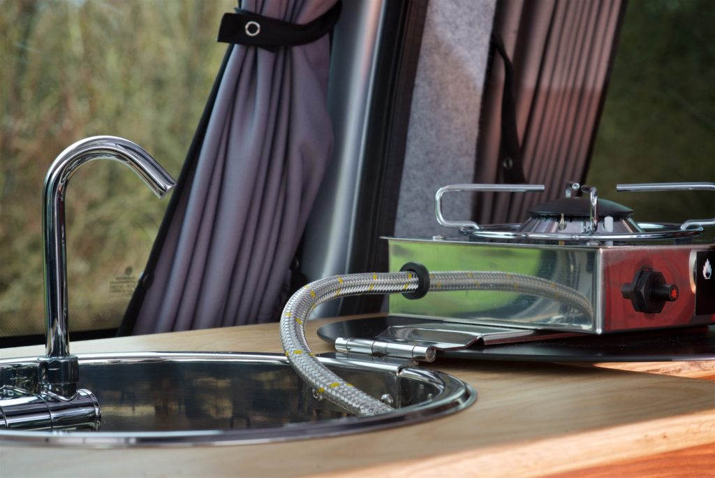 VW caddy campervan conversion close up of a CAN foldy sink and hob